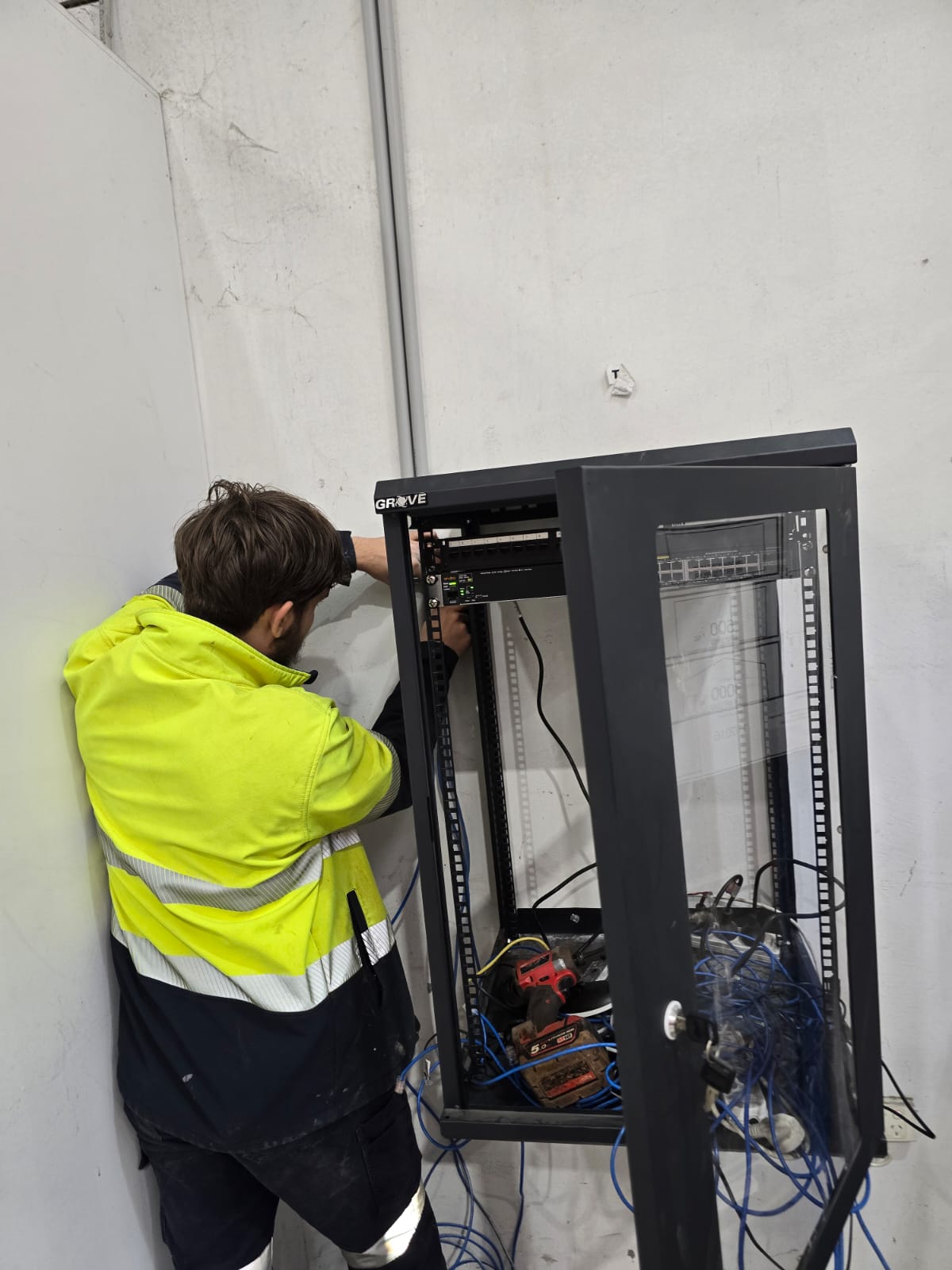 Professional data rack relocation in Cannington office showing organized network cabling and power connections
