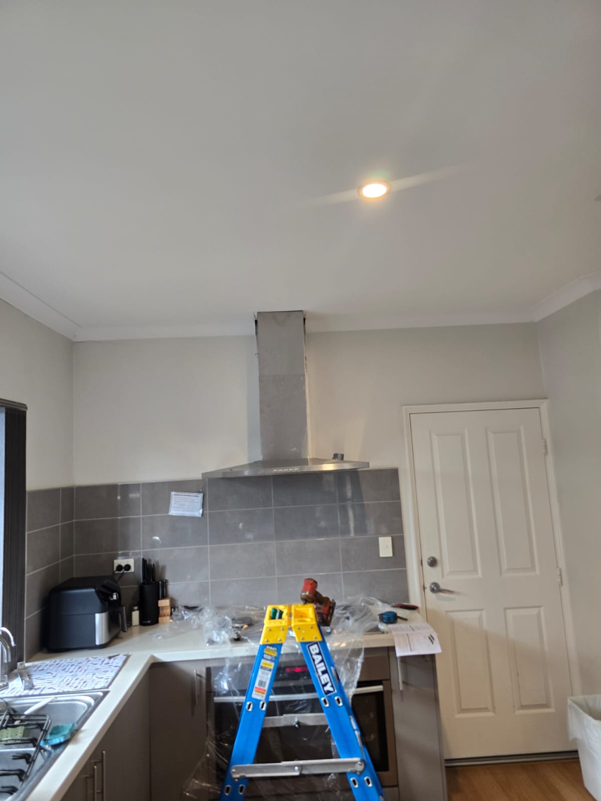Residential kitchen electrical upgrade in Perth showing rangehood installation and new power point outlets